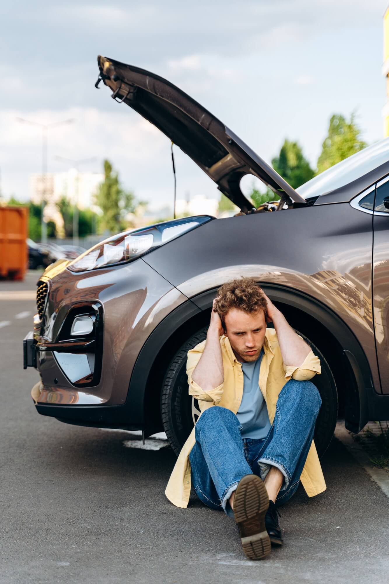 young-guy-near-the-car-with-an-open-hood